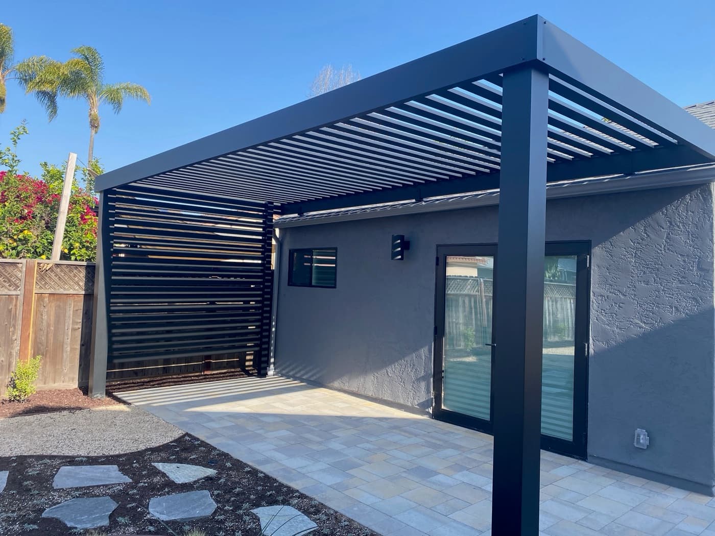 Louvered pergola over a paver patio in Del Mar by Modern Yardz