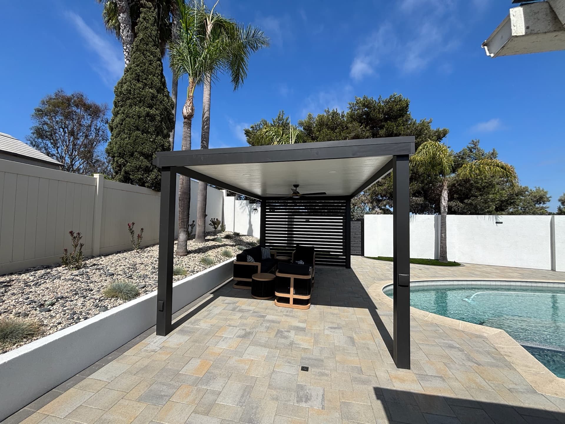 Louvered pergola and poolside pavers, designed and built by Modern Yardz in Coronado, San Diego County