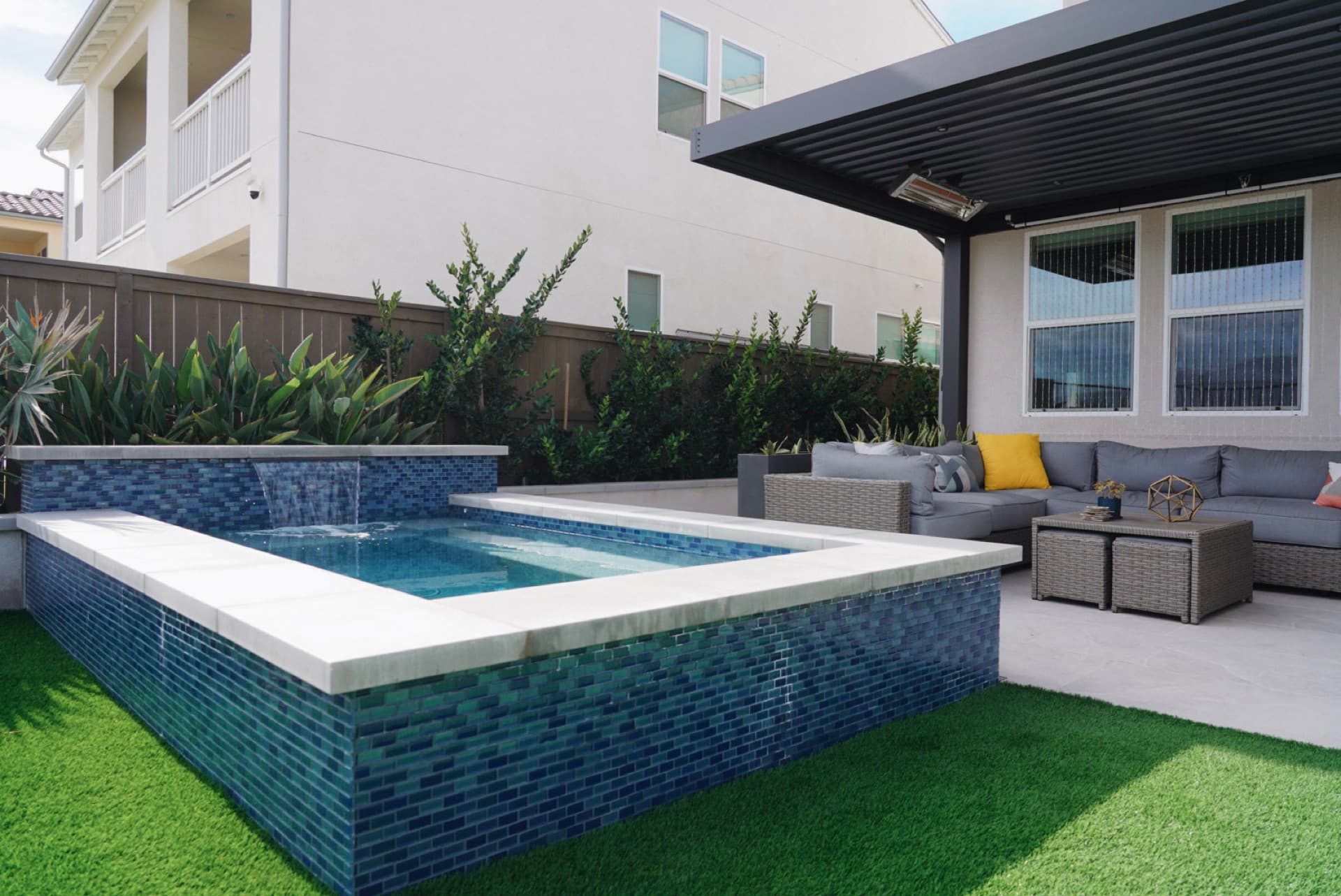 Blue-tile spa and pool with a louvered pergola, designed and built by Modern Yardz in Oceanside, San Diego County