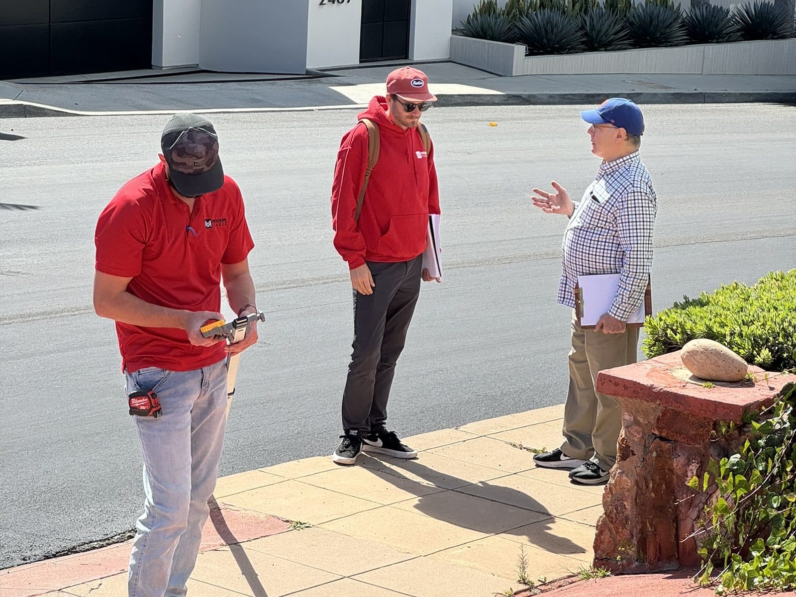 Modern Yardz designer measuring a San Diego property during a free landscape design consultation